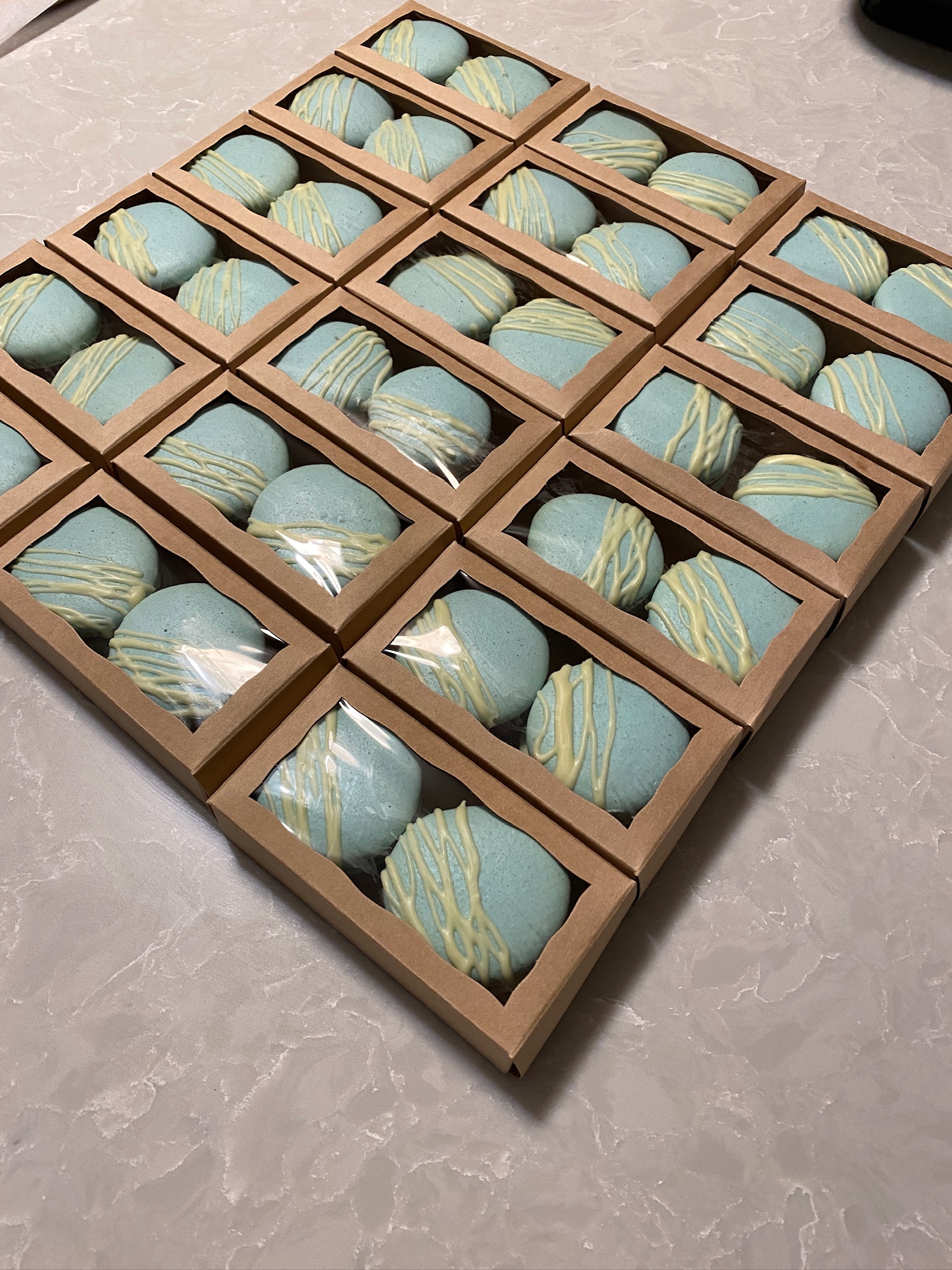 An order of Macaron arranged in favor boxes.