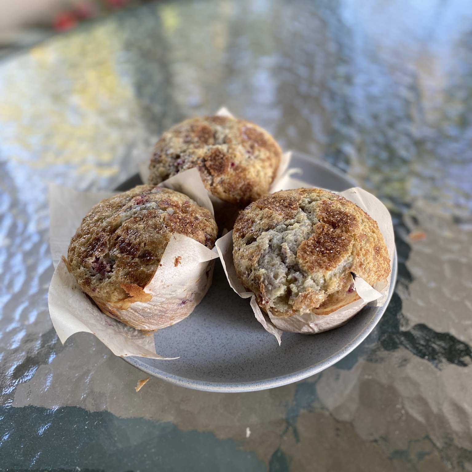 Three muffins on a plate.